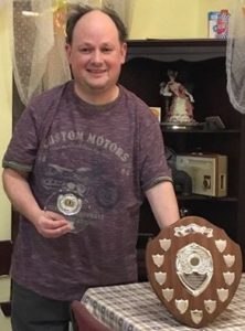 David Leathar standing with the sheild