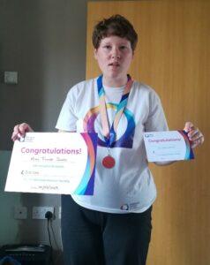 Fiona Jones, one of our learner's holding two certificates for her work with the National Autistic Society