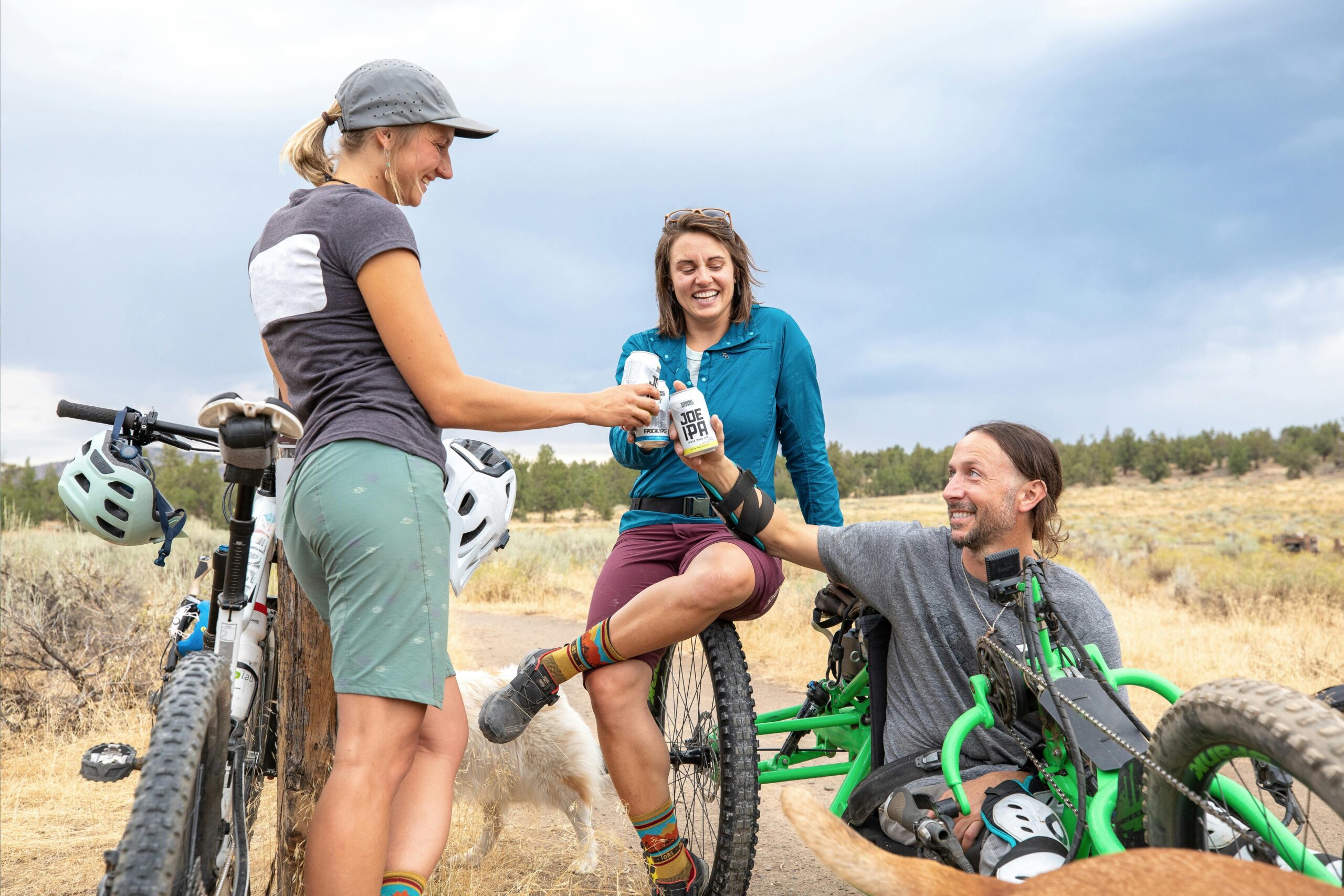     Three cyclists stop for a drink