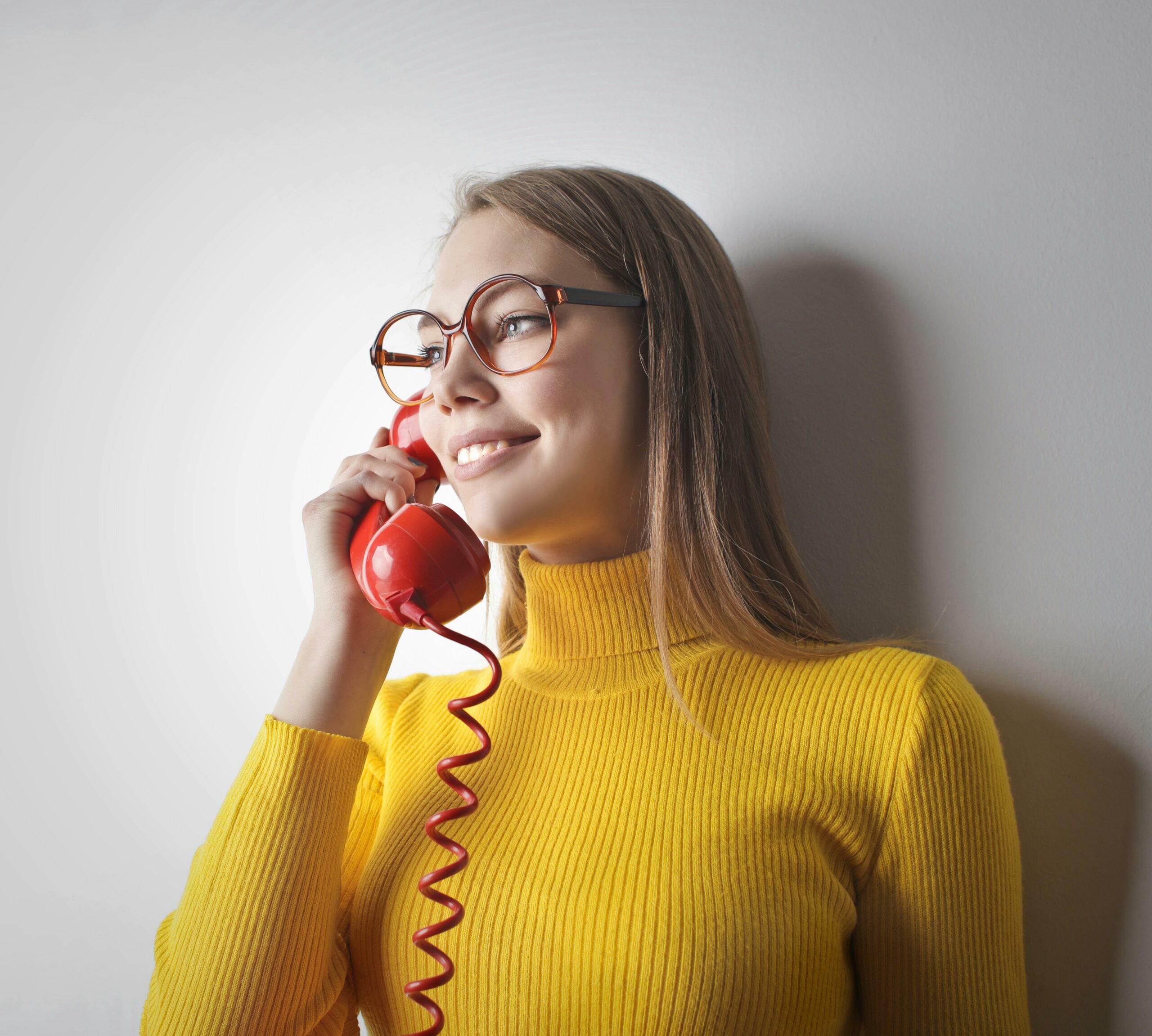     A female using an old fashioned phone