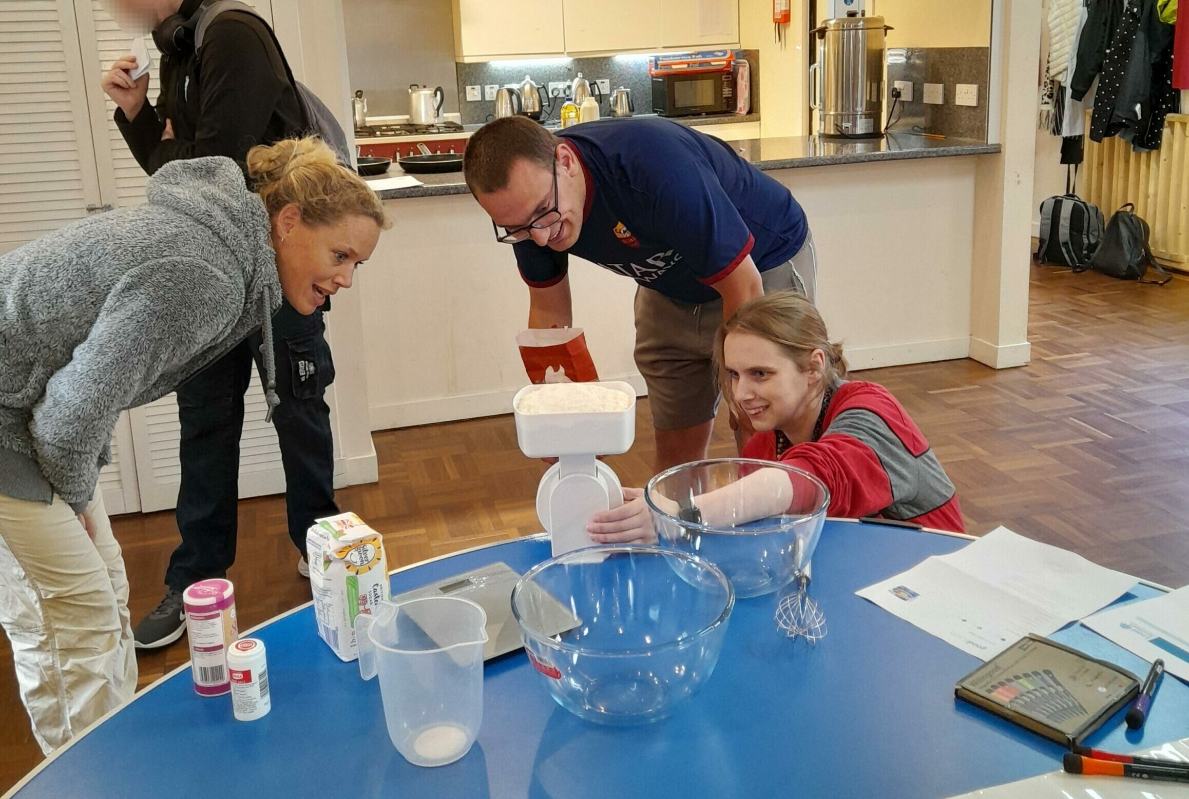     Lead staff helping a learner with his weighing skills